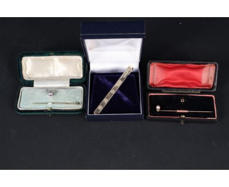 A 9ct gold millennium hallmarked tie clip, two 9ct gold shirt studs and two yellow metal pearl set stick pins (boxed)