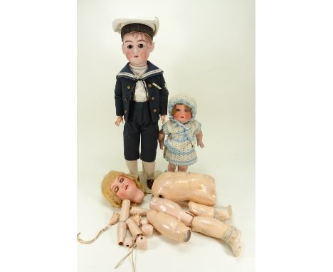 A large Max Handwerck bisque head child doll, German circa 1910, with weighted brown glass eyes, open mouth with upper teeth,