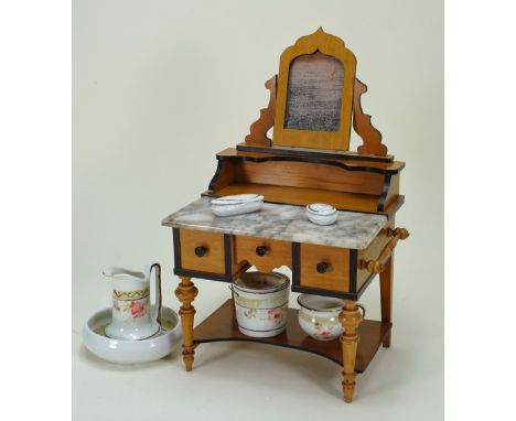 A good dolls cherry wood and marble wash stand, German circa 1890, with turned legs, three drawers, towel rail, marble top wi