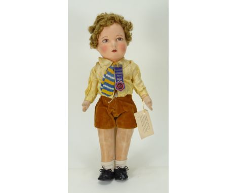 A Chad Valley young boy cloth doll, 1930s, the moulded felt face with painted features, short curly brown hair, swivel head a