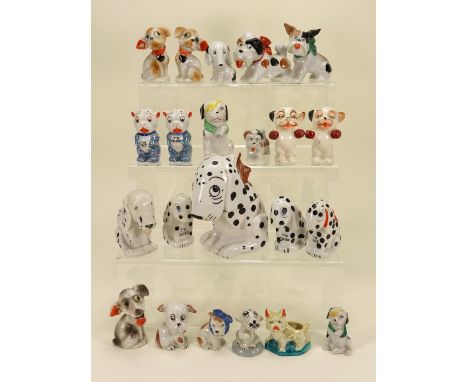 Collection of Dismal Desmond and other glazed china dog figurines, five seated Dismal Desmonds largest a jar 5 ½” (14cm) tall
