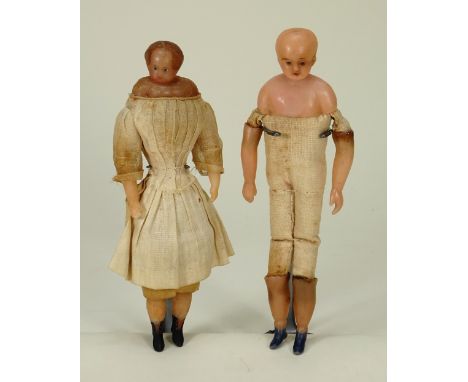 Two Early bees wax shoulder head dolls, English circa 1850, the first with painted features and brown hair-style, on a cloth 