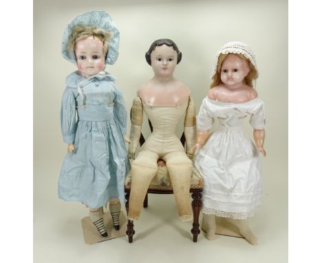 Two large German wax-over shoulder head dolls, one with fixed blue glass eyes, painted mouth and rouge cheeks, remains of she