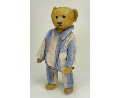 A Schuco Yes/No Teddy Bear, 1920s, the golden short mohair bear with black boot button eyes, stitched nose and mouth, jointed
