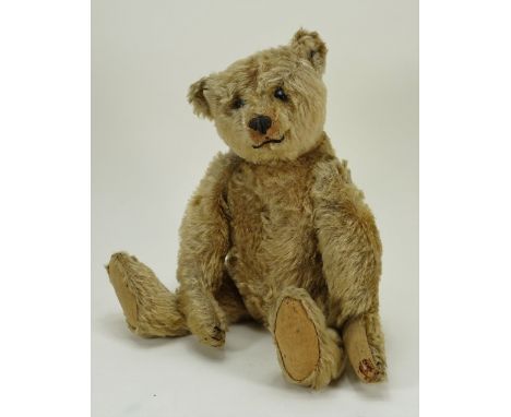 A good centre seam Steiff Teddy bear, German circa 1909, the straw filled tan mohair bear with black boot button eyes, pronou