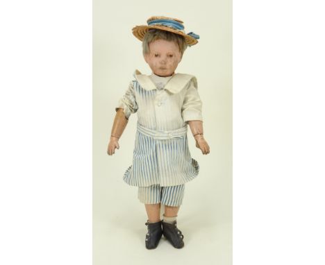A carved wooden Shoenhut doll, German circa 1910, sweet boy with painted brown eyes, and short brown wig, swivel head to meta