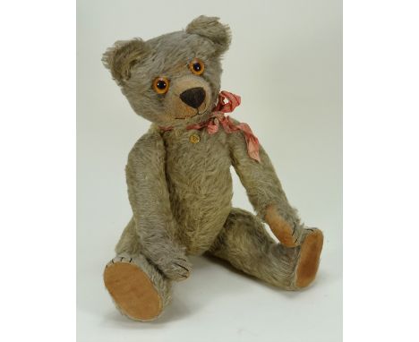 Early Chad Valley Teddy bear, English early 1920s, straw filled tan mohair bear with large orange glass eyes, clipped muzzle 