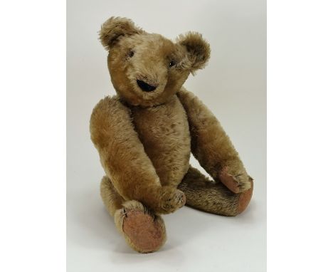 A good early English mohair Teddy Bear, circa 1912, the straw filled brown mohair bear with black boot button eyes, black sti