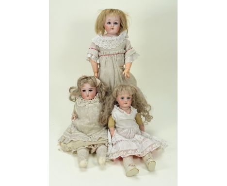 Three German bisque shoulder head dolls, circa 1915, including a Heubah girl with weighted blue glass eyes, painted and real 