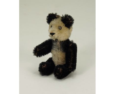 Miniature Schuco Panda bear, German 1920s, the black and white mohair bear with black metal eyes, stitched nose and mouth, sw