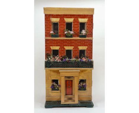 A wooden Silber and Flemming box back dolls house, German late 19th century, on a green painted base with red brick and sand 