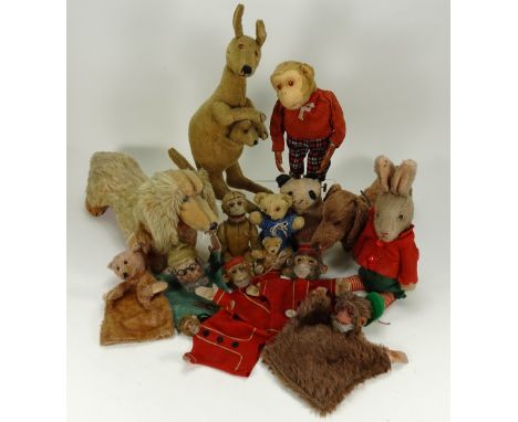 Collection of various soft toys, including yes/no rabbit with glass eyes, wearing a red felt jacket, green shorts and striped