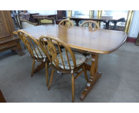 An Ercol dining table and four chairs