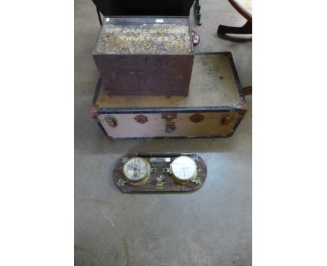 A marine barometer and clock, bearing H.M.S. Barlow, travel trunk and a metal deed box