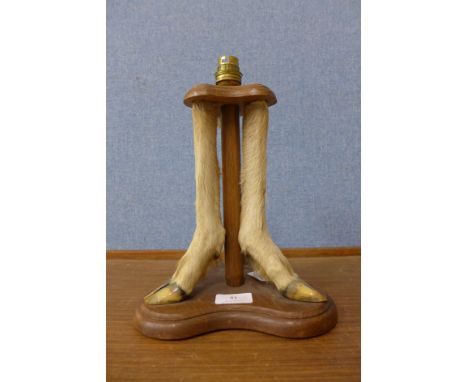 A taxidermy deer leg table lamp