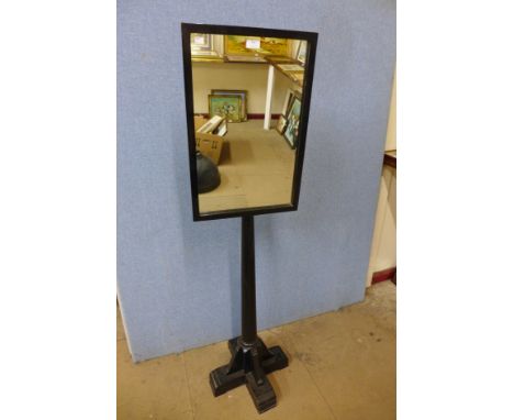 A Victorian ebonised shaving mirror on stand