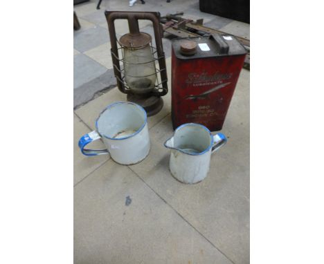 Two enamel jugs, a storm lantern and a Silkolene oil can