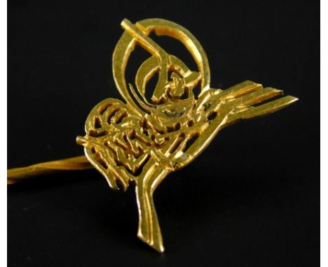 A stick pin, with abstract carved design, yellow metal, unmarked, 2.3g.  (M)