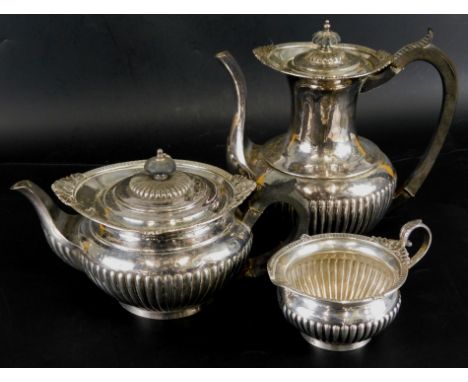 An Edwardian Walker & Hall silver three piece tea service, comprising coffee pot, 23cm high, teapot, 15cm high, and a milk ju
