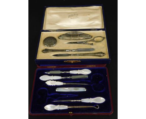 Two early 20thC part manicure sets, to include one in retailer's box for Van Damme of Bruges, another with mother of pearl mo
