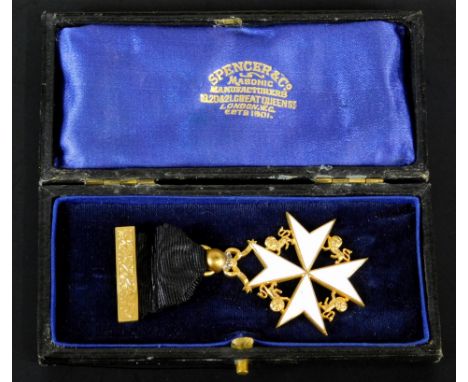 A Masonic medal by Spencer & Co of London, the white enamel cross surrounded by gilt metal lions, gold ribbon, in fitted leat