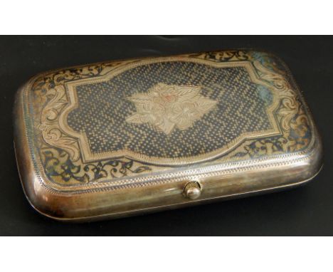 A late 19thC Russian Niello white metal cigarette case, with design of cartouche, flowers and scrolls, with silver gilt inter