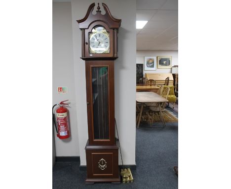 A contemporary Tempus Fugit longcase clock with pendulum and weights