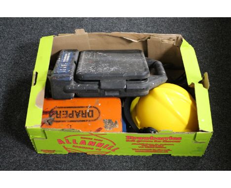 A box containing hard hat, hand tools etc