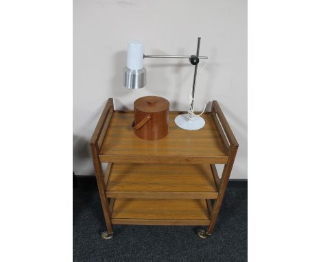 A teak serving trolley, a lamp and a lidded caddy