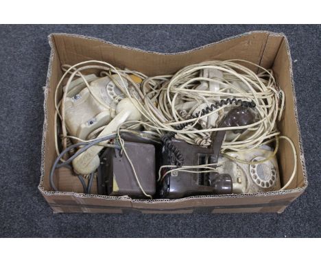 A box of vintage telephones