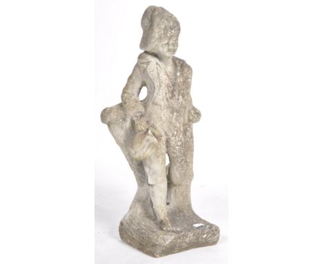 A vintage 20th Century reconstituted stone garden exterior decorated statue in the form of a young boy. The figure modelled b