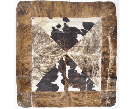 A retro vintage 20th Century 1970s&nbsp;taxidermy cow skin / hide floor carpet rug of large rectangular form. Dark hide borde