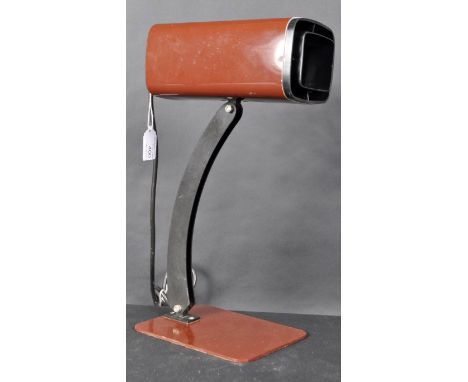 A bedside / desk lamp light, a rectangular brown shade supported on a black curved tilt arm, on a flat rectangular base, with