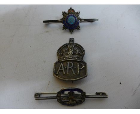 A SILVER WORLD WAR II A.R.P. BADGE AND TWO SILVER AND ENAMEL BROOCHES (3) 