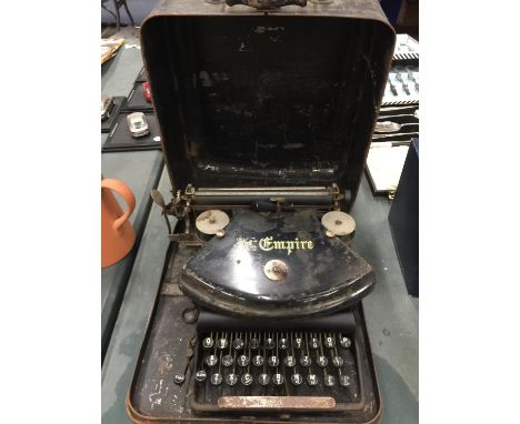 A VINTAGE 'THE EMPIRE' TYPEWRITER IN METAL CASE 