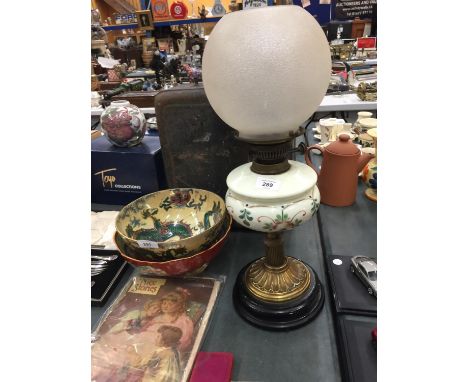 AN OIL LAMP ON WOODEN BASE 