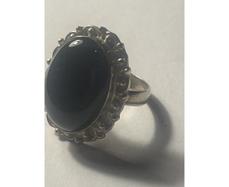 A SILVER RING WITH A BLACK OPAL CENTER STONE 