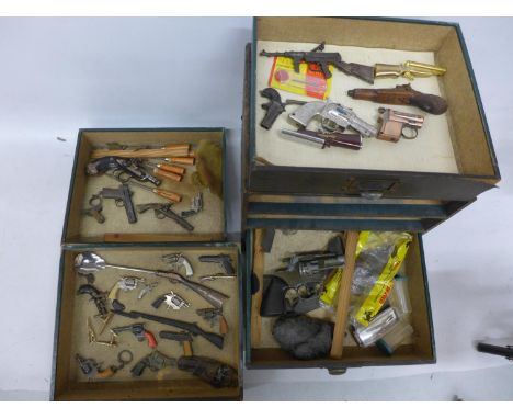 A LARGE COLLECTION OF TWENTY-EIGHT MINIATURE MODEL PISTOLS AND RIFLES, TOOLS ETC, CONTAINED IN A FOUR DRAWER CABINET 