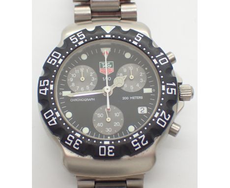 TAG HEUER gents midi F1 quartz chronograph wristwatch having subsidiary dials and tritium chapters on a steel bracelet togeth