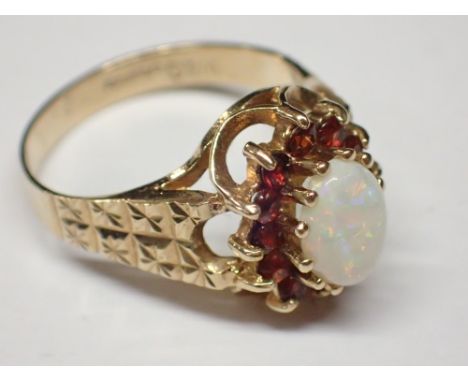 9ct gold opal and red stone ring size J 2.4g  CONDITION REPORT: Ring is undamaged