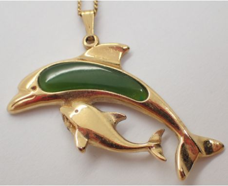 New Zealand made nephrite jade and yellow metal dolphin on a plated chain 