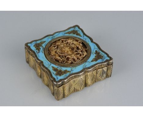 A 20TH CENTURY CONTINENTAL GILT WHITE METAL AND ENAMEL COMPACT, of square outline, engraved decoration, the hinged cover inse