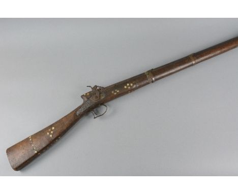 AN ANTIQUE NATIVE PERCUSSION MUSKET, fitted with a 47'' barrel, the stock has some mother of pearl inlay, its lock is defecti