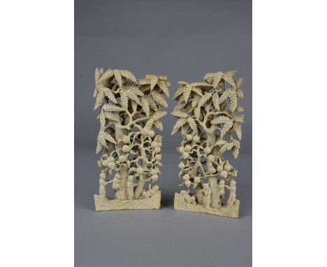 A PAIR OF 19TH CENTURY CHINESE IVORY WRIST RESTS, carved as fruit trees with figures on the ground and child climbing a trunk