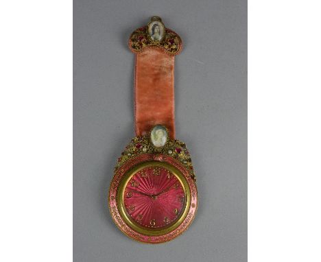 AN EARLY 20TH CENTURY SCHILD &amp; CO GILT METAL AND PINK ENAMEL EIGHT DAY TRAVEL CLOCK, hanging loop above an oval miniature