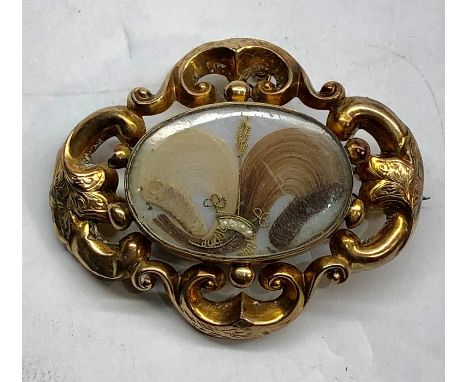 Antique gold mourning brooch set with pearl mounted hair in fancy gold brooch not hallmarked but acid tested as gold measures