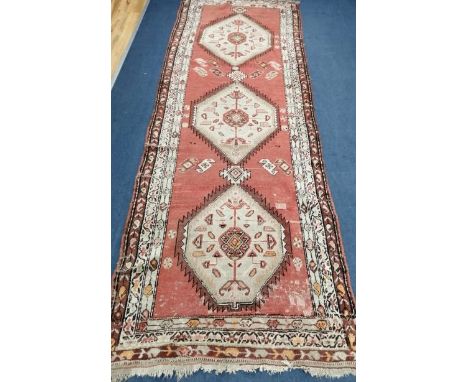 A Caucasian red ground runner 290 x 100cm