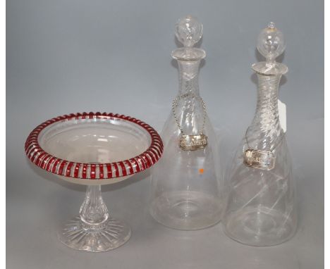 A pair of late Regency glass decanters, with silver Claret labels and a ruby overlaid cut glass comport