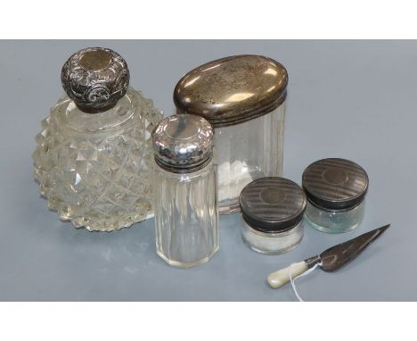 A silver-mounted scent bottle, four other toilet jars and a trowel book mark.