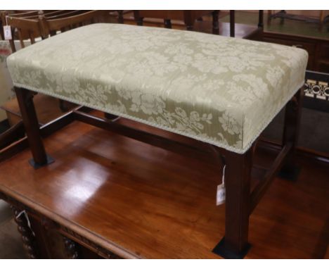 A Georgian style stool, with green upholstery and chamfered legs W.92cm